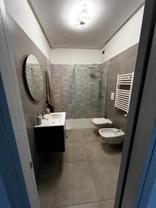 a bathroom with two sinks and two toilets at Brezza di Bari, Terrace & Free Parking, family and group apartment by Leviora Collection in Bari +27 photos
