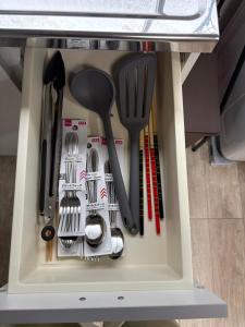 a drawer filled with cooking utensils and spatulas at シーシャイン北金沢 102号室 in Aomori