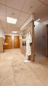 a large room with a hallway with doors and a tile floor at Der Marienhof Hotel Garni in Graz +83 photos