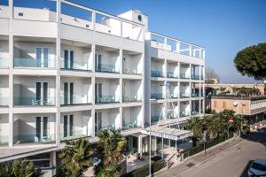 an apartment building with balconies and a street at Hotel Oceanomare in Punta Marina