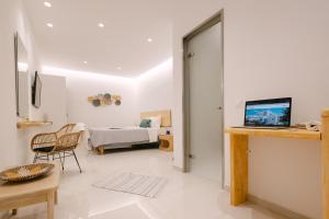 a living room with a room with a bed at Anemos Hotel & Apartments in Ornos