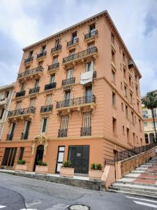 a large orange building with balconies on a street at Eden Riviera in Beausoleil
