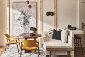 a living room with a chair and a table at Laudinella Apartments in St. Moritz