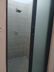 a shower with a glass door in a bathroom at The Views Apartments in Kariba +39 photos