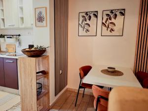 a kitchen with a table and a small table and chairs at Studio Apartment MD in Roč