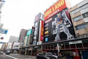 a busy city street with buildings and cars on the street at 大阪難波ELLY-ten in Osaka +3 photos
