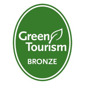 a green tourism promise sign in a green circle at Royal Scots Club in Edinburgh