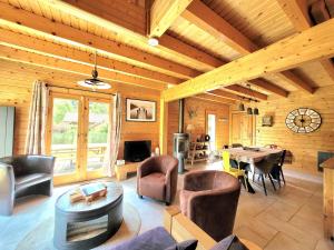 a large living room with a table and chairs at Chalet Cocoon 6p avec Spa privé in Rochesson