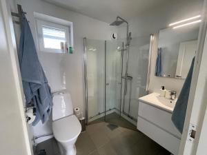 a bathroom with a shower and a toilet and a sink at Siam Homestay 2 in Mölndal