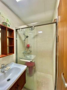 a bathroom with a shower and a sink at 8F-08 Overlooking Condo at Megatower 3 in Baguio