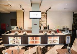 a kitchen with a counter with a tv on top at Aston Gorontalo Hotel & Convention Center in Gorontalo