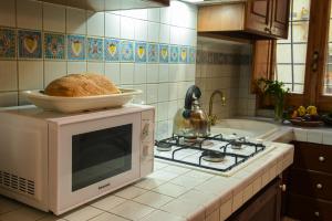 a loaf of bread sitting on top of a microwave at SCAPPO IN UMBRIA, nel vicolo in Amelia +17 photos
