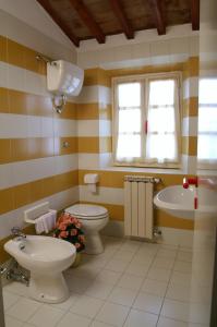 ein Badezimmer mit 2 WCs und einem Waschbecken in der Unterkunft Hotel Calzaiolo in San Casciano in Val di Pesa