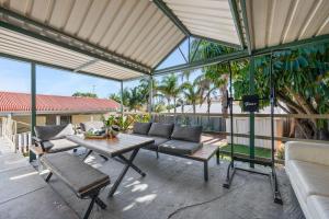 a screened in porch with a table and chairs at Bedford Pool Oasis - Comfort near CBD & Airport in Perth