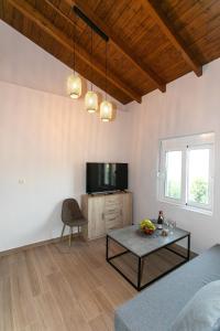 a living room with a couch and a table at Akrolithia Guest House in Valanidorachi