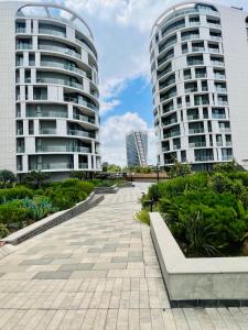 a walkway in front of two tall buildings at Executive Studio at Ellipse Galileo - Waterfall in Midrand