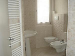 a bathroom with a toilet and a sink at Villa Gaia Apartments pool wifi parking in Malcesine +50 photos