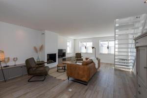 a living room with a couch and two chairs at Welcome in - Familiehuis met ruim terras en speelweide I Oostkapelseweg 32, Serooskerke 'Ooievaar' in Serooskerke
