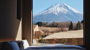 a view of a snow covered mountain from a window at THE THIRD PLACE Mt Fuji in Fujikawaguchiko