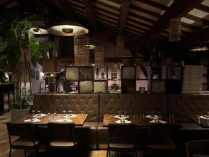 a dining room with tables and chairs and a ceiling at Hôtellerie du Roy - Restaurant Chez Robin in Sainte-Hélène-sur-Isère
