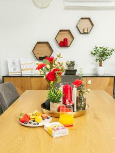 a table with a tray of fruit and juice on it at Vadvirág 5 by DunaVibe in Baja