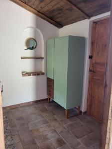 a green cabinet in a room with a door at La Terrazza Segreta - Vista Mare in Atri