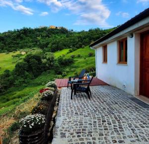 a patio with two chairs and a table on a house at La Terrazza Segreta - Vista Mare in Atri