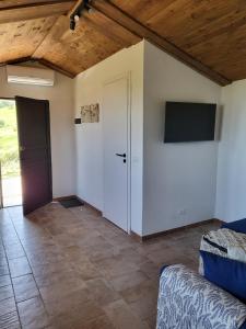 a room with a door and a tv on the wall at La Terrazza Segreta - Vista Mare in Atri