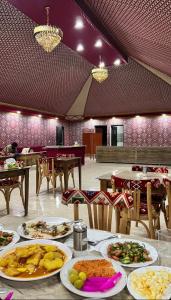 a table with plates of food in a restaurant at Rum Four Seasons luxury Camp & Jeep Tours in Wadi Rum