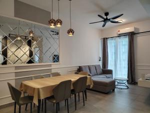 a living room with a table and a couch at Sunsuria Forum Soho by Diamond in Shah Alam