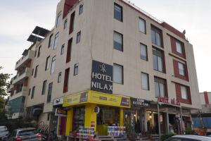 a large building with a hotel miliya on a street at Hotel Nilax in Jaipur