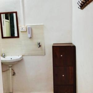 a bathroom with a sink and a mirror at Dapolihideaway in Dapoli +3 photos