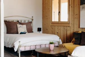 a bedroom with a bed and a table and a couch at La Villa d'Hélène Chambre d'hôtes BnB - Cluses - Parking Voiture - Moto - Vélo in Cluses