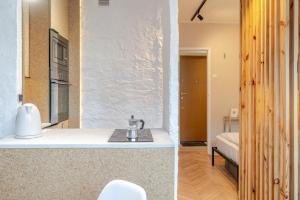 a kitchen with a sink and a room with a bed at Sosnowiec Downtown Studio by BookingHost in Sosnowiec +20 photos