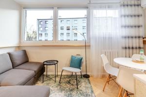 a living room with a couch and a table at Sosnowiec Downtown Studio by BookingHost in Sosnowiec