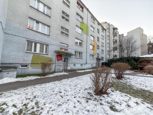 a snow covered street in front of a building at Sosnowiec Downtown Studio by BookingHost in Sosnowiec
