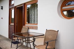 a patio with a table and chairs on a porch at SOL Panzió in Bük