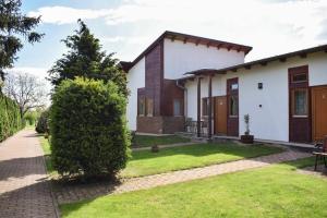 a house with a green lawn in front of it at SOL Panzió in Bük