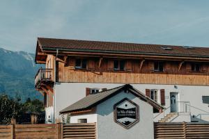 a building with a sign on the front of it at La Villa d'Hélène Chambre d'hôtes BnB - Cluses - Parking Voiture - Moto - Vélo in Cluses