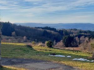 a view of a grassy field with a river at chambre basique, endroit magique in La Renaudie