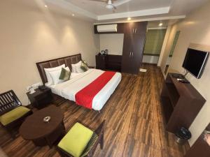 a hotel room with a bed and a television at Hotel Nilax in Jaipur +45 photos