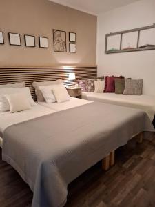 two beds sitting next to each other in a room at Studio Apartment MD in Roč