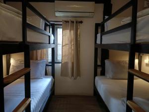 a bunk bed room with two bunk beds at Imchai in Pai