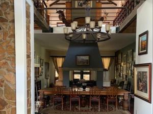 a dining room with a table and a chandelier at Waterval Karoo Guest Farm in Laingsburg +15 photos
