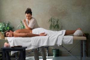 a woman laying on a bed next to a man at Tibet Boutique Hotel Annex in Kathmandu