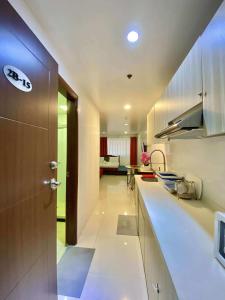 a kitchen with a counter and a door in a room at 2B-15 Condo Staycation at Megatower 1 in Baguio
