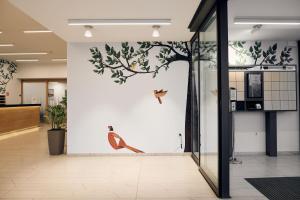 a hallway with a wall with birds on it at Hotel Park in Čakovec