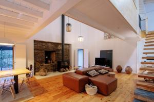 a living room with a couch and a fireplace at Quinta do Vale da Ermida, Private - Heated - Pool in Ermida