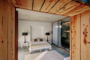 a bedroom with a bed and a large window at Quinta do Vale da Ermida, Private - Heated - Pool in Ermida +64 photos