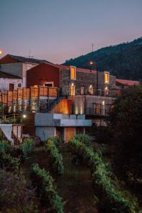 a large building with a building at night at Quinta do Vale da Ermida, Private - Heated - Pool in Ermida